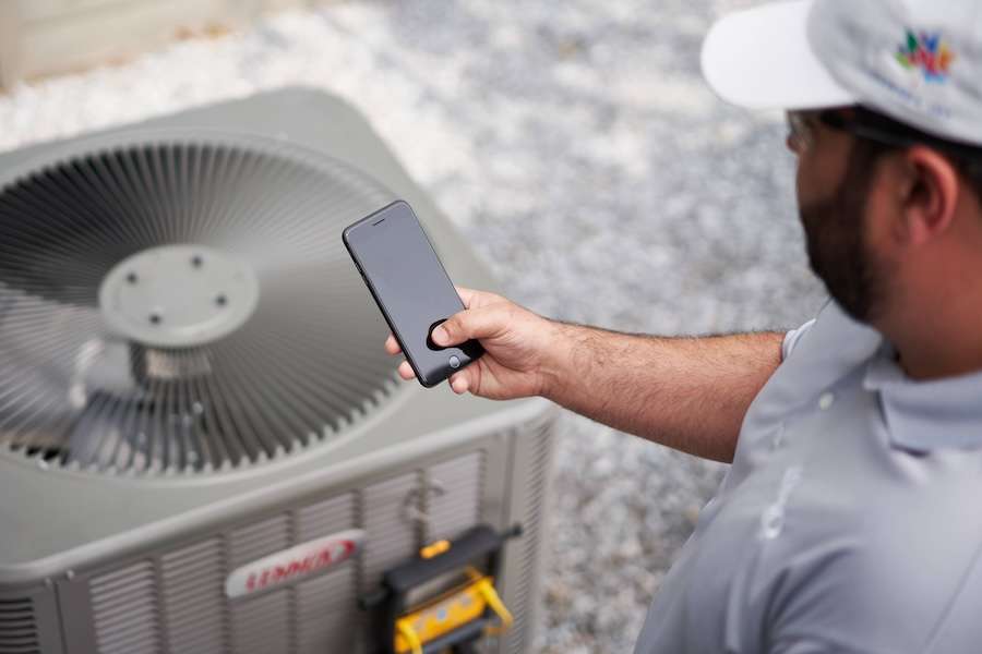 Purified Air technician servicing heating equipment