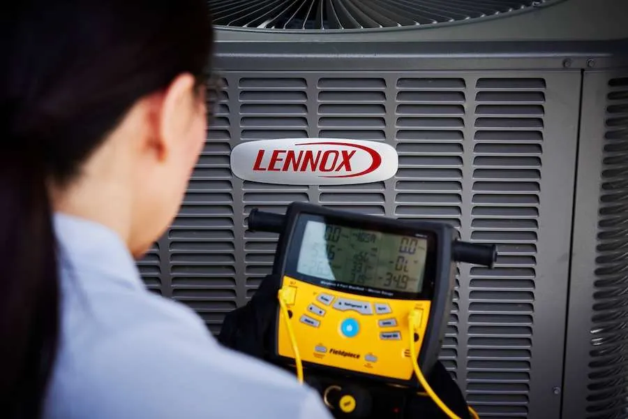Technician testing a Lennox air conditioner
