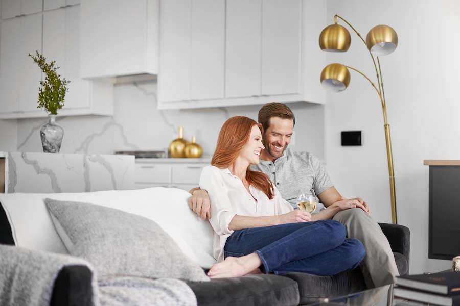 Couple relaxing comfortably on a sofa in a bright living room